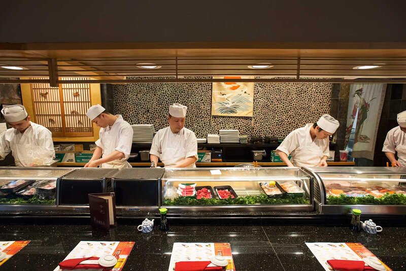 Sushi chefs at sushi bar